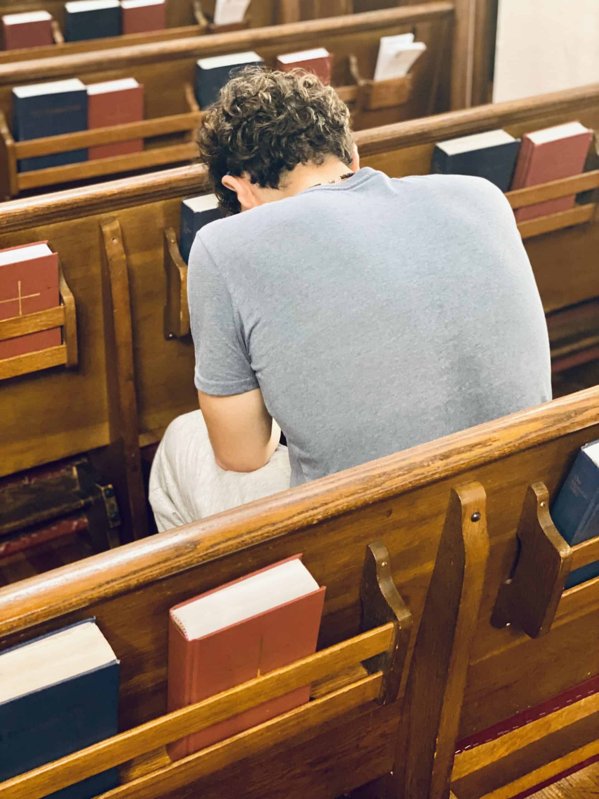 Person praying in pew at Saint Andrew's Episcopal Church.