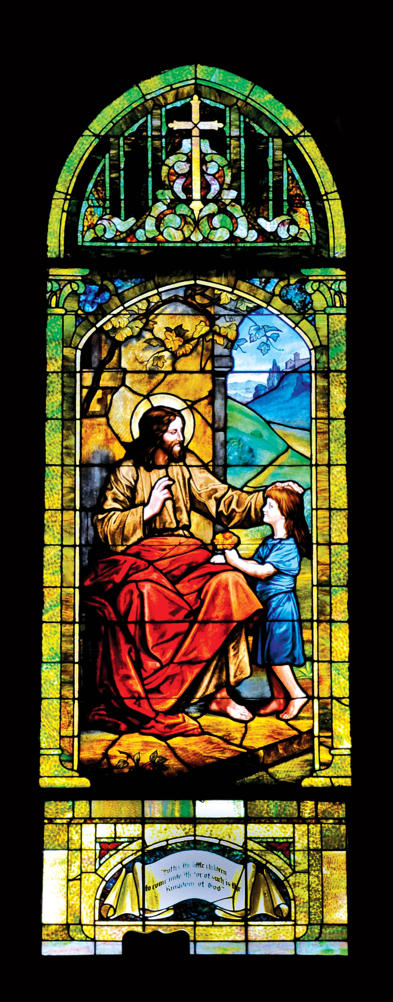 Stained glass window depicting Jesus blessing a child at Saint Andrew's Episcopal Church.