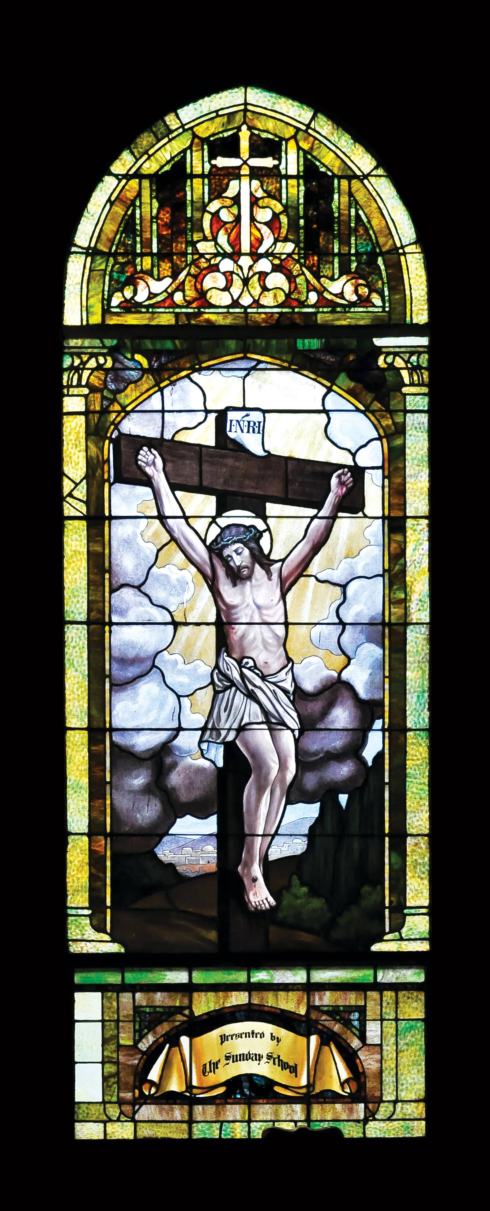Stained glass window depicting Jesus Christ on the cross at Saint Andrew's Episcopal Church.