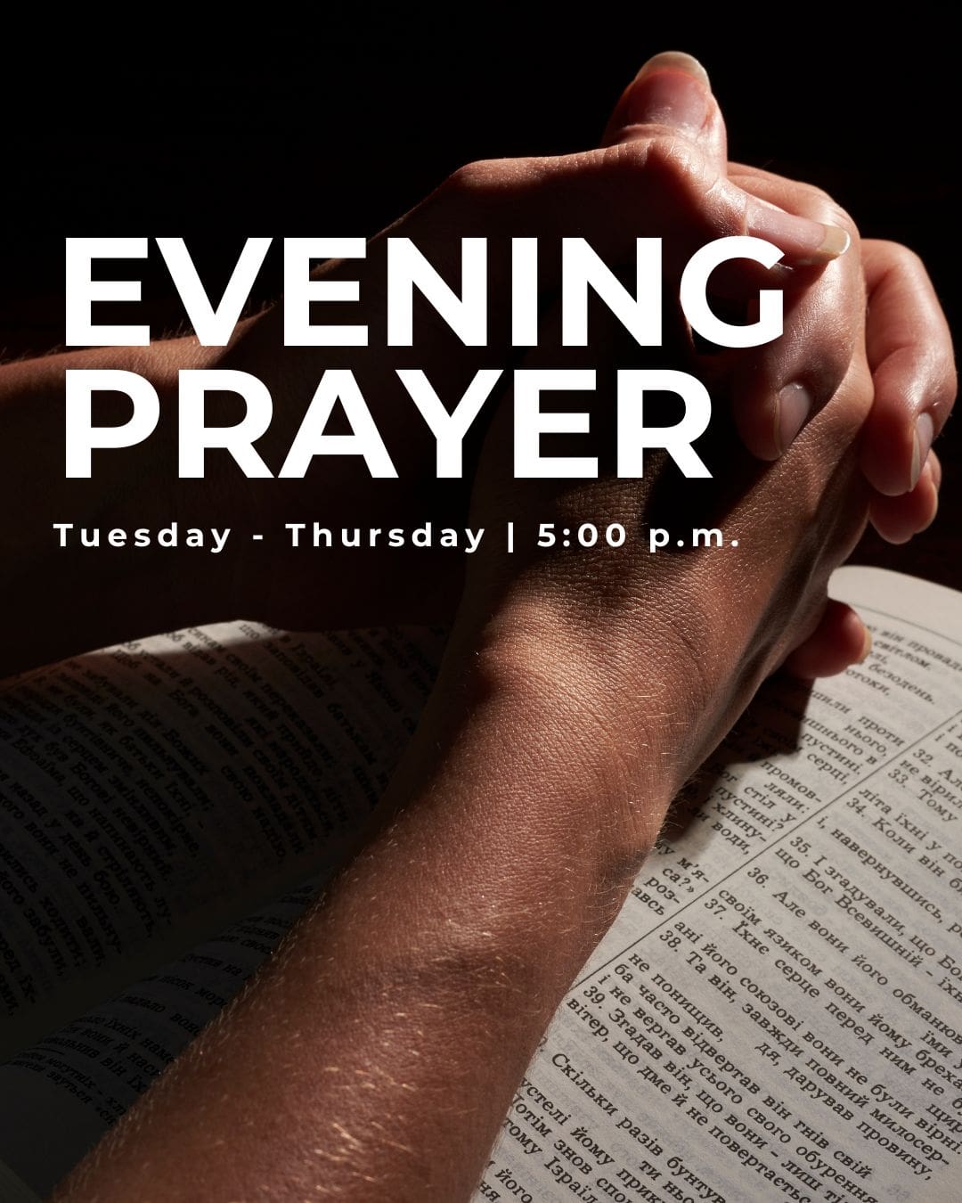 Person praying with hands clasped over an open Bible promiting evening prayer services.